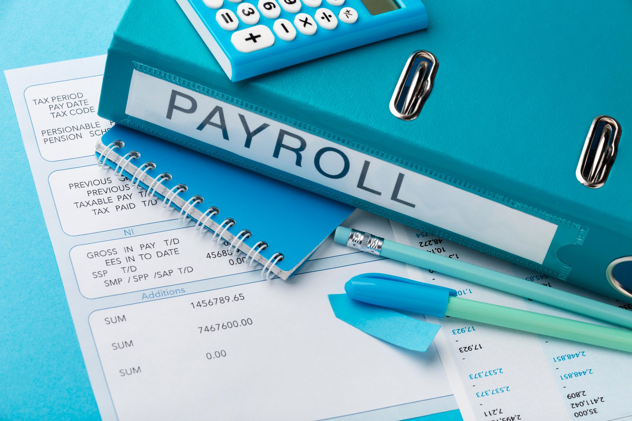 Business owner reviewing payroll documents with advisor